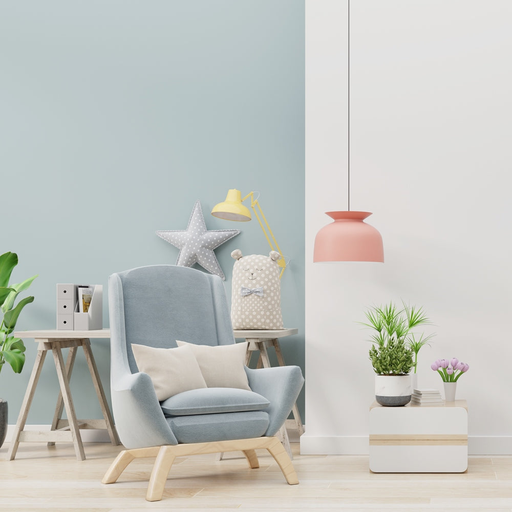 Modern living room with a gray armchair, decorative items, and plants.
